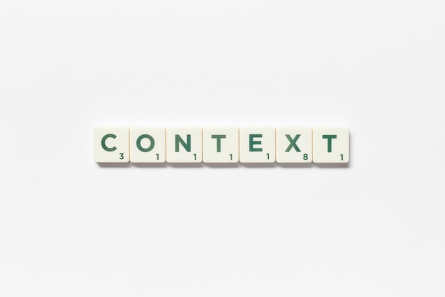 Context formed of scrabble tiles on white background