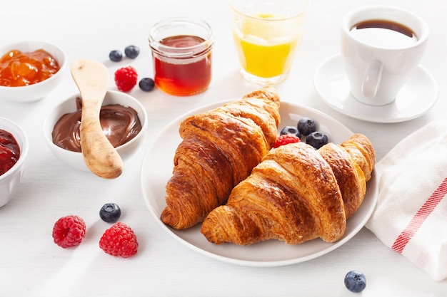 Continental breakfast with croissant,  jam, chocolate spread and coffee