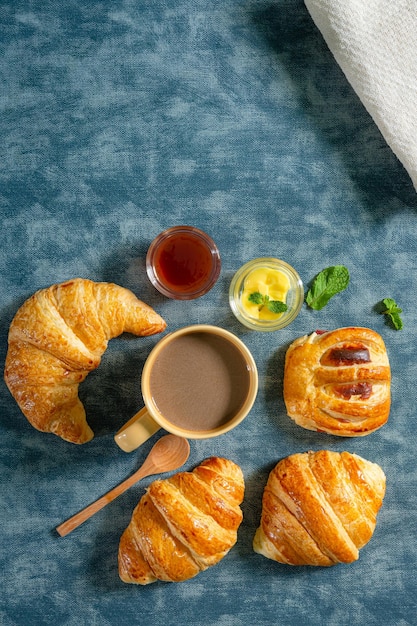 Continental breakfast with fresh croissants orange juice and coffee selective focuse