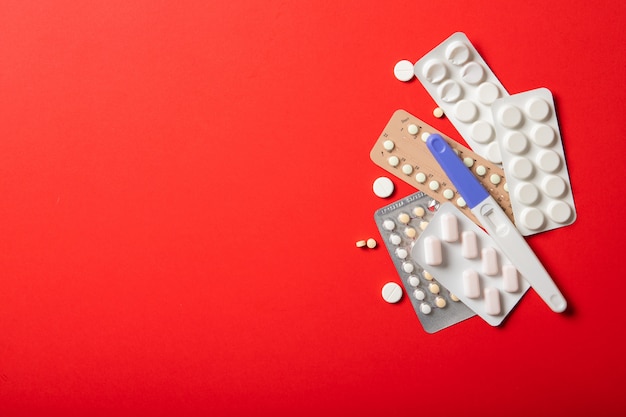 Contraceptive pill blisters on a red background