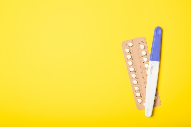 Contraceptive pill blisters on a yellow background