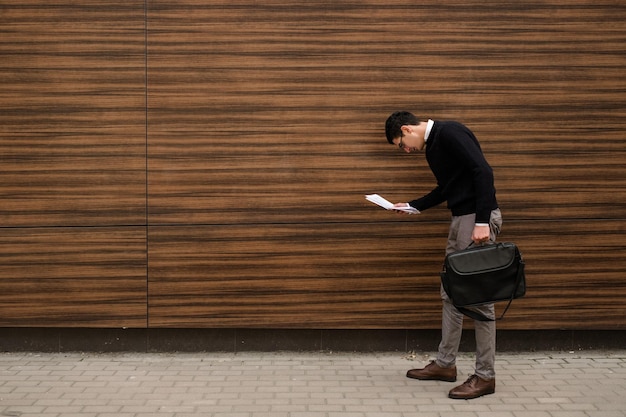 contract details. puzzled business man looking into papers. free space concept