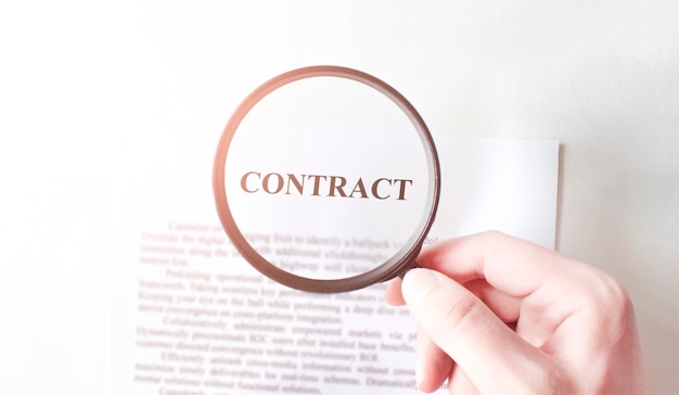 Contract with pen and magnifying glass. Business concept