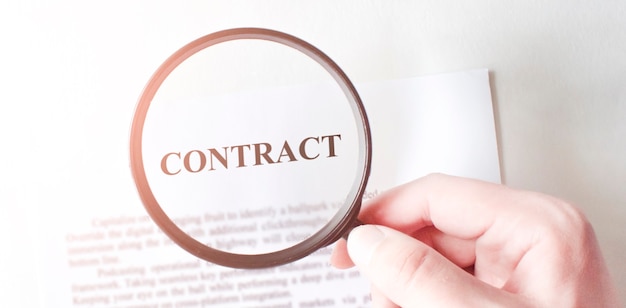 Contract with pen and magnifying glass. Business concept