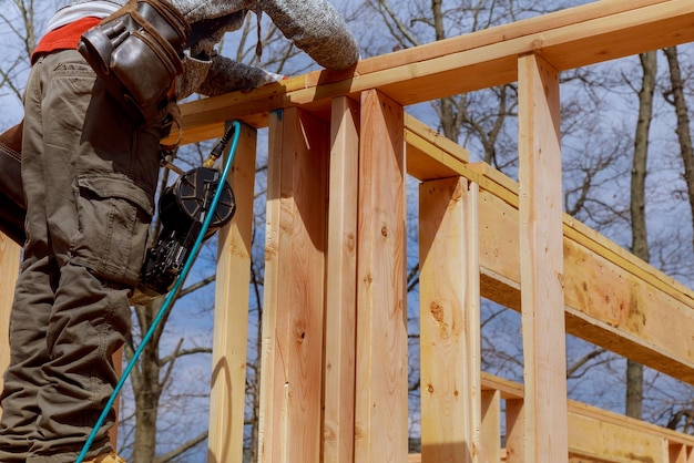 Photo contractor framing up wall section for a framing building custom house