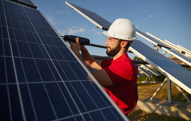 Contractor installing solar panel in field