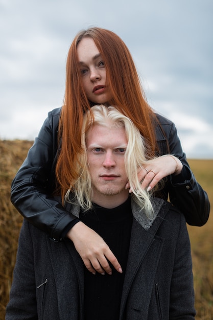 A contrasting pair of unusual looks posing in the frame.