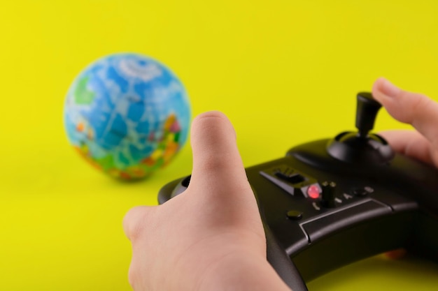 The control panel is in children's hands and a globe