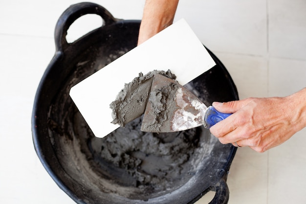 contruction mason worker hands with cement mortar