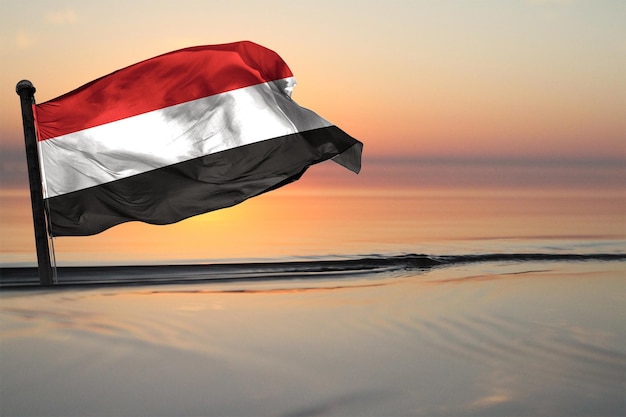 A Contry of yemen National Flag on a see backgrund