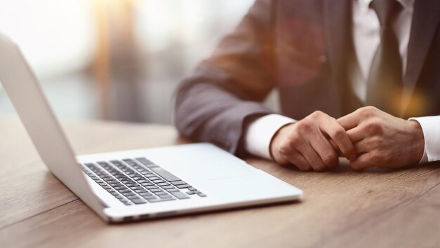 Convenient workplace Closeup of a comfortable workplace in the office with a wooden table lying on it and a laptop