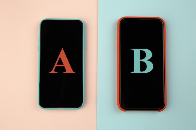 Conversion funnel, A B test in marketing and online advertising. Two smartphone with colored letters A and B on colorful background.