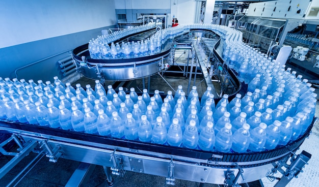 Conveyor belt with bottles of drinking water at a modern beverage plant