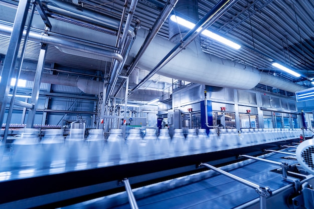 Conveyor belt with bottles of drinking water at a modern beverage plant