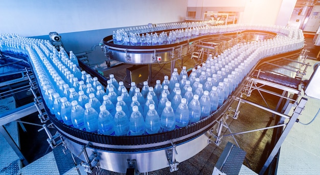 Conveyor belt with bottles of drinking water at a modern beverage plant