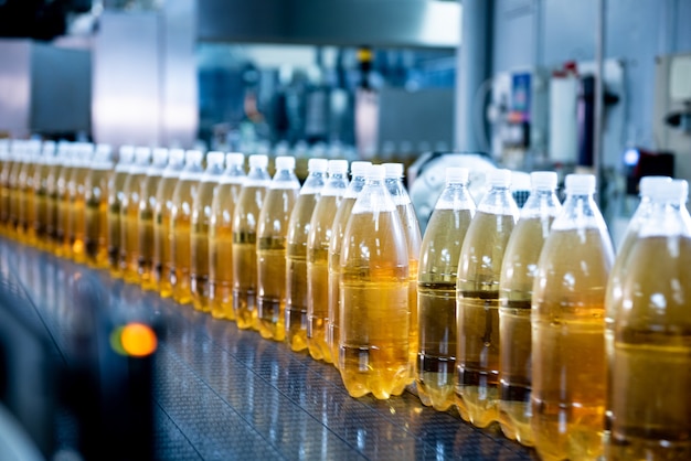 Conveyor belt with bottles for juice or water at a modern beverage plant