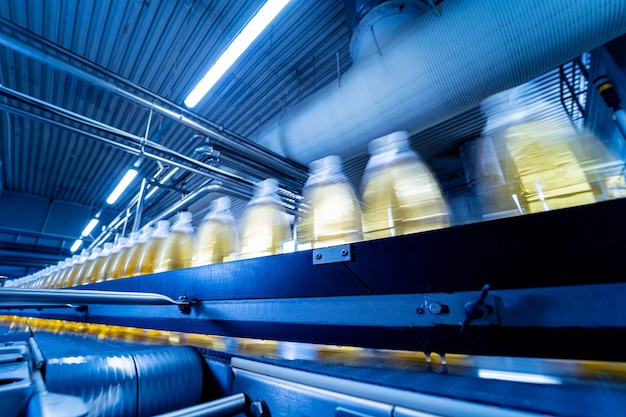 Conveyor belt with bottles for juice or water at a modern beverage plant