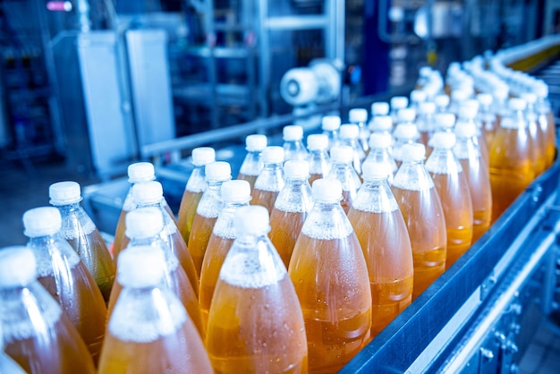 Conveyor belt with bottles for juice or water at a modern beverage plant