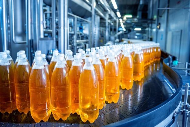 Conveyor belt with bottles for juice or water at a modern beverage plant