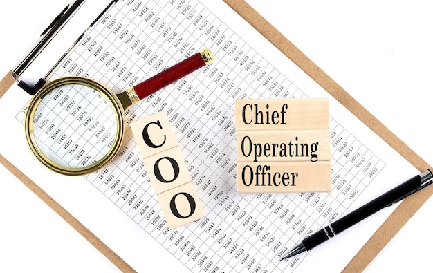 COO Chief Operating Officer text on wooden block on chart background