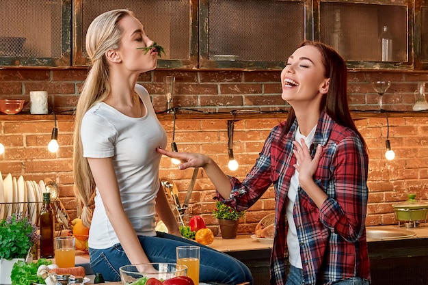 Cood cooks never lack friends young female friends preparing together vegetarian meal in modern