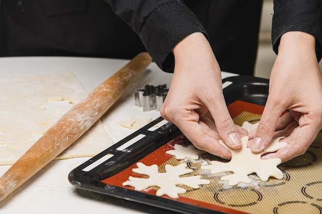 Cook the chef rolls the dough for the cookies.