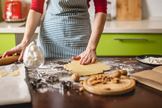 カラフルなキッチンで自宅でクッキーを作る主婦を調理する