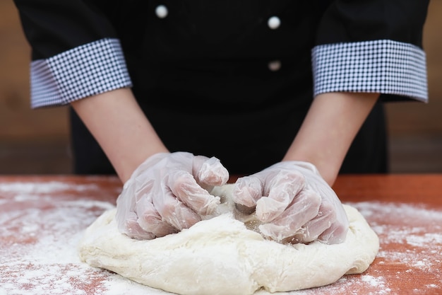 the cook makes flour out of flour for baking on the table