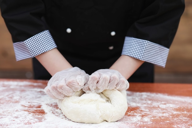 the cook makes flour out of flour for baking on the table