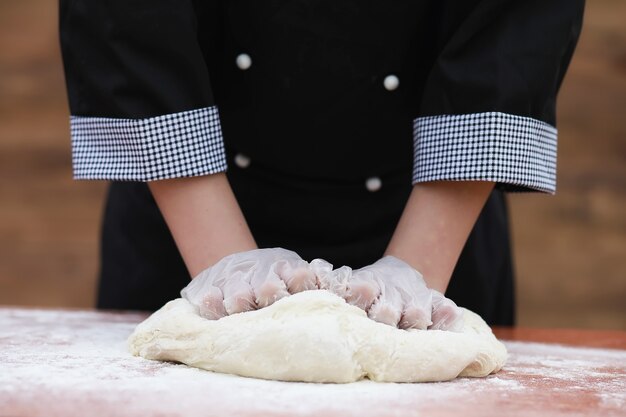 the cook makes flour out of flour for baking on the table