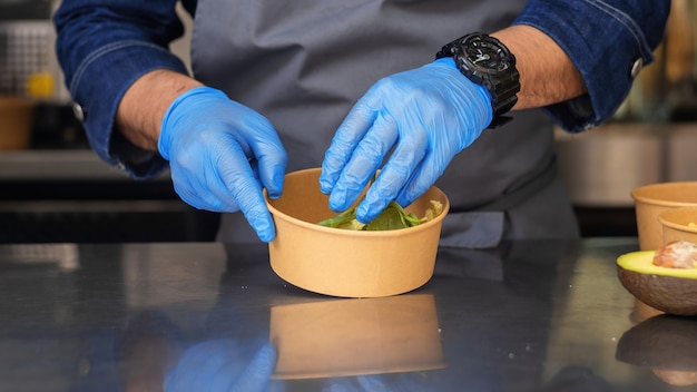 Cook making salad, adding ingridients, food truck