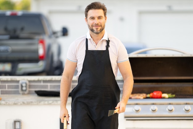 Cook man preparing barbecue grill outdoor man cooking tasty food on barbecue grill at backyard chef