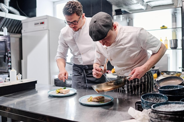 Cook putting garnish on plate