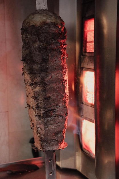 a cook slices doner kebab