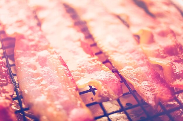 Cooked bacon strips on a baking sheet.