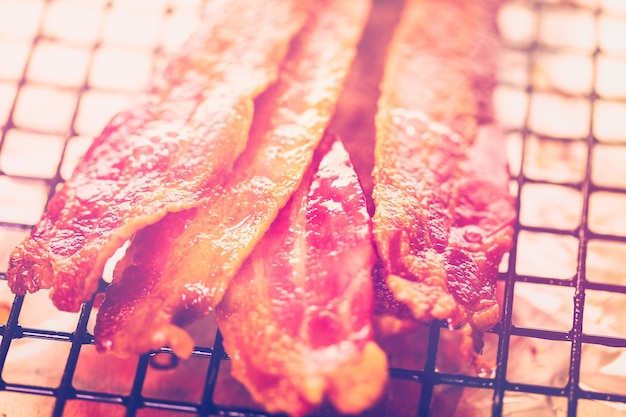 Cooked bacon strips on a baking sheet.