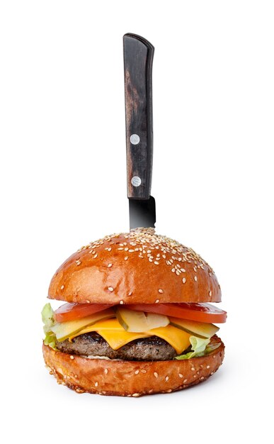 Cooked burger with pinned knife isolated on white background