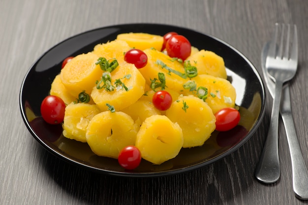 Cooked cassava with cherry tomato