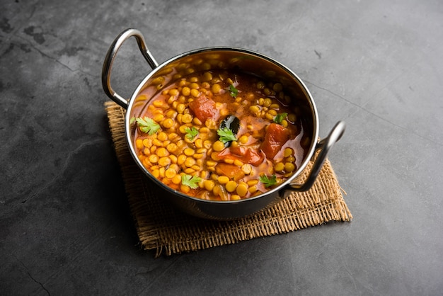 Cooked Chana Dal fry or Split Bengal Gram tadka served in a bowl or pan, selective focus