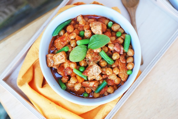 Cooked chickpeas with  meat and green beans. Spanish traditional food.