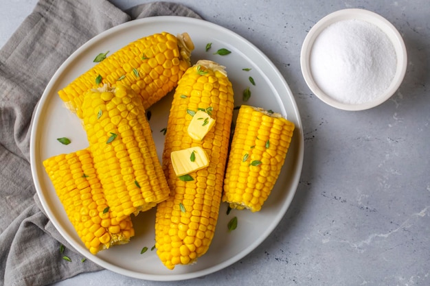 Cooked corn on the cob served with salt and butter simple summer dish