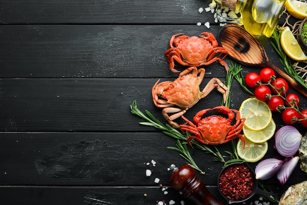 Cooked crabs with spices on a black background Top view Free space for your text