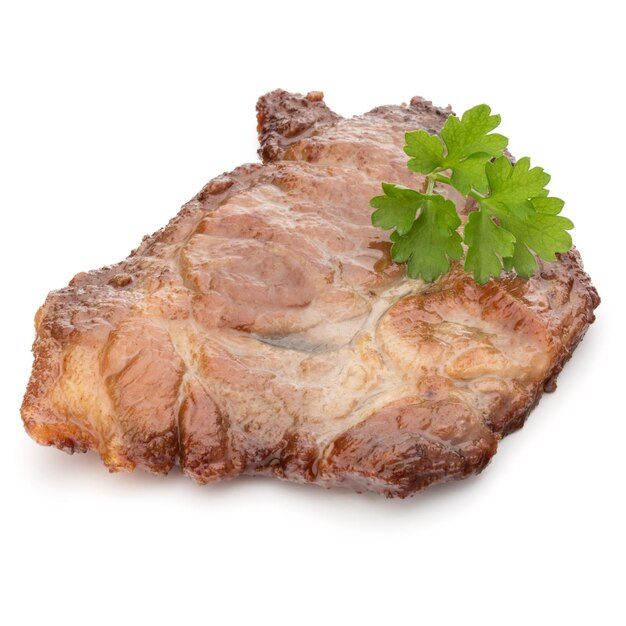 Cooked fried pork meat with parsley herb leaves garnish isolated on white background cutout