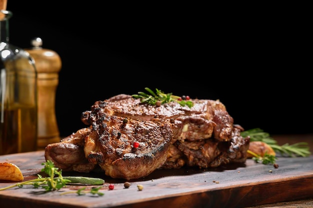 Cooked juicy steak meat beef with seasoning on wooden chopping board