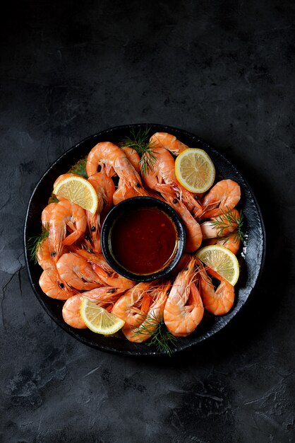 Cooked large shrimps with lemon, dill, and tomato sauce