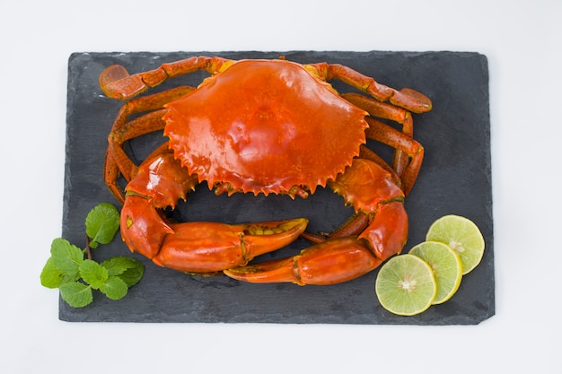 Photo cooked mud crab which is red in color arranged on a graphite sheet