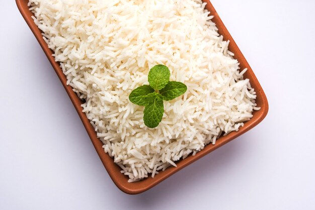 Cooked plain white basmati rice in terracotta bowl