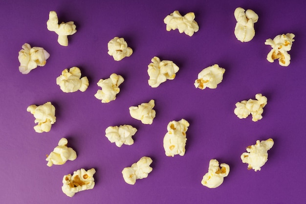 Cooked popcorn on a violet background