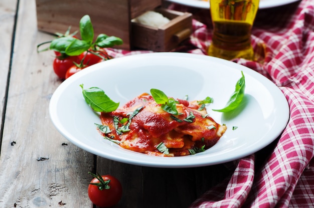 Cooked ravioli with tomato and basil
