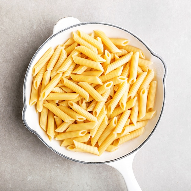 Cooked ready italian penne in white pan